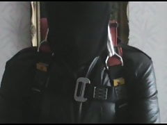Straitjacketed slave is suspended