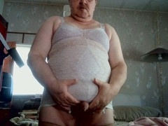 Milky guy in girdles and a bra enjoys some solo action