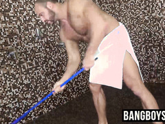 Man with muscles is stroking his giant prick under the shower