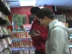 Dude sucking on a big gay dick at the video store gloryhole