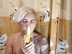 Sweet boy eats a banana greedily