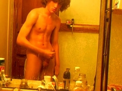 Curly-haired twink in bathroom