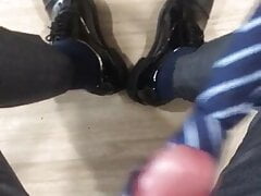 suited man plays with his tie