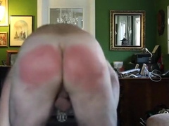 Paddled whilst bare except for a male chastity device