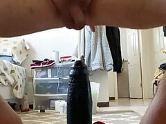PrettyEan sitting on huge black dildo