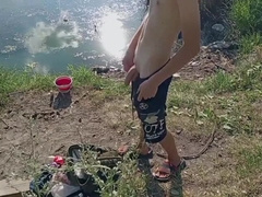 Dude stroking off in nature and fishing