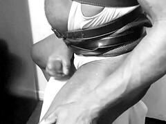 Kinky black slutty bodybuilder poses and cums in singlet and leather boots