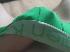 The fellow caresses his lollipop thru green briefs.