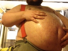 Oiled-up construction worker indulges in his grizzly fetish, smoking a cigar and embracing his chubby physique