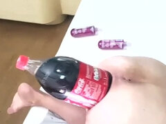 Big soda bottle is penetrating her tight asshole