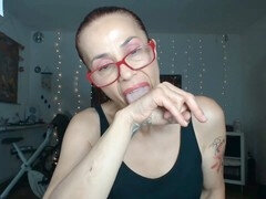 Mistress Claudia covers her middle finger in drool and humiliation