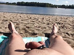 Naked on the beach watching the boats go by.