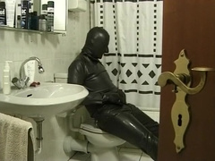 Latex Encased Man Masturbating on Toilet