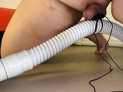 Small Penis With Vibrator Eggs Holding A Vacuum Hose