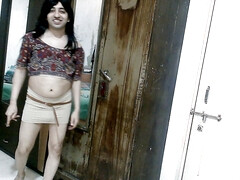 Sexy sissy crossdresser femboy Sweet Lollipop in a printed blouse and nude skirt.