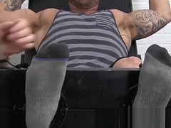 Huge muscular dude endures a feet tickling torment