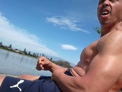 Muscular guy Sun Jerk gets naughty by the lake with an outdoor solo session
