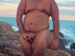 Inexperienced gay with a chubby physique explores public pleasure at the beach