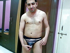 Hot nude boy trying out his new sexy multi-color printed thong.