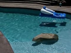 Sporty jock relaxes by the pool and strokes his shaft