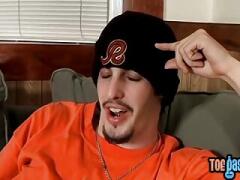 Inked stud teases with his toes and strokes his boner