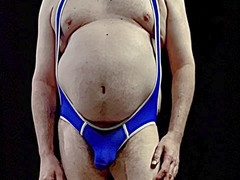 Mature coach with massive belly suits up in a tight singlet and shows off his bulge