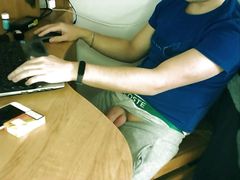 Teen boy jerking off by the desk while working online