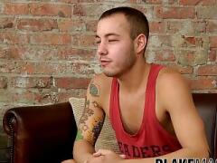 Tattooed young man fingers his ass while jerking off solo