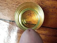Cumming in a glass of sunflower oil