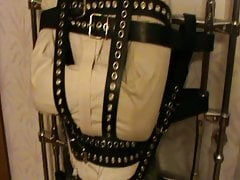 Straitjacketed slave is restrained to the grid