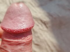 Cum alarm on the beach crowned Glans splashes on Sand