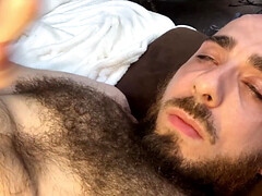 Very hairy bald guy with blue eyes tries to cum in his own mouth but only makes it to his chest