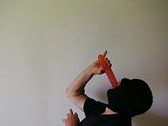 Hooded masked man deepthroat a plastic cock dildo
