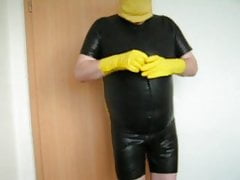 in my tight rubber short suit showing my fat man tits