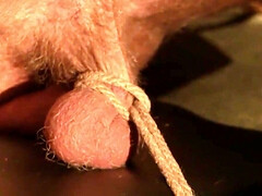 Painful teasing by a dom while he is tied up with a rope