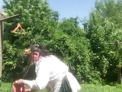 In planter's outfit, hanging laundry