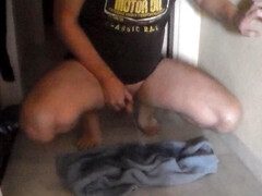John is peeing on a towel in the hallway