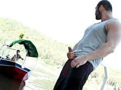 Muscular bottom rides cock on a wooden pier