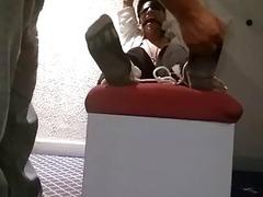 Tickling a bound man's bare feet