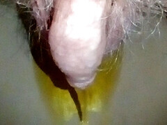 Closeup of John pissing in the porta potty