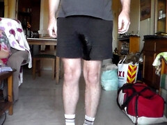John is Peeing in his black shorts