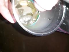 Me peeing pissing in a cup outside just because