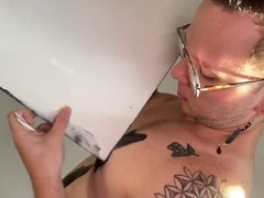 Muscular geek paints before jerking off and cumming on himself