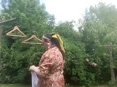 In vintage floral pattern dress for a day hanging laundry
