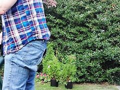 Gardener dad moving plants, then takes a break for a smoke