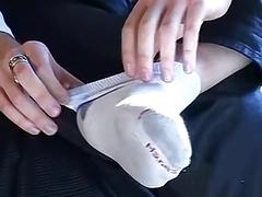 Stud removes shoes and socks before massaging his bare feet
