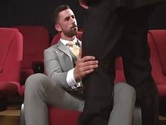 Gay hunks undress at the cinema for anal sex