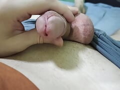 Masturbates his cock, strokes his balls and ends up with juicy cum