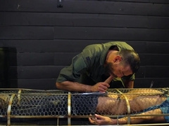 Caged male slave lets master feast with his erect cock