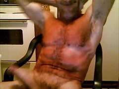 Muscledude sitting dicked,, stroking cock and cummin